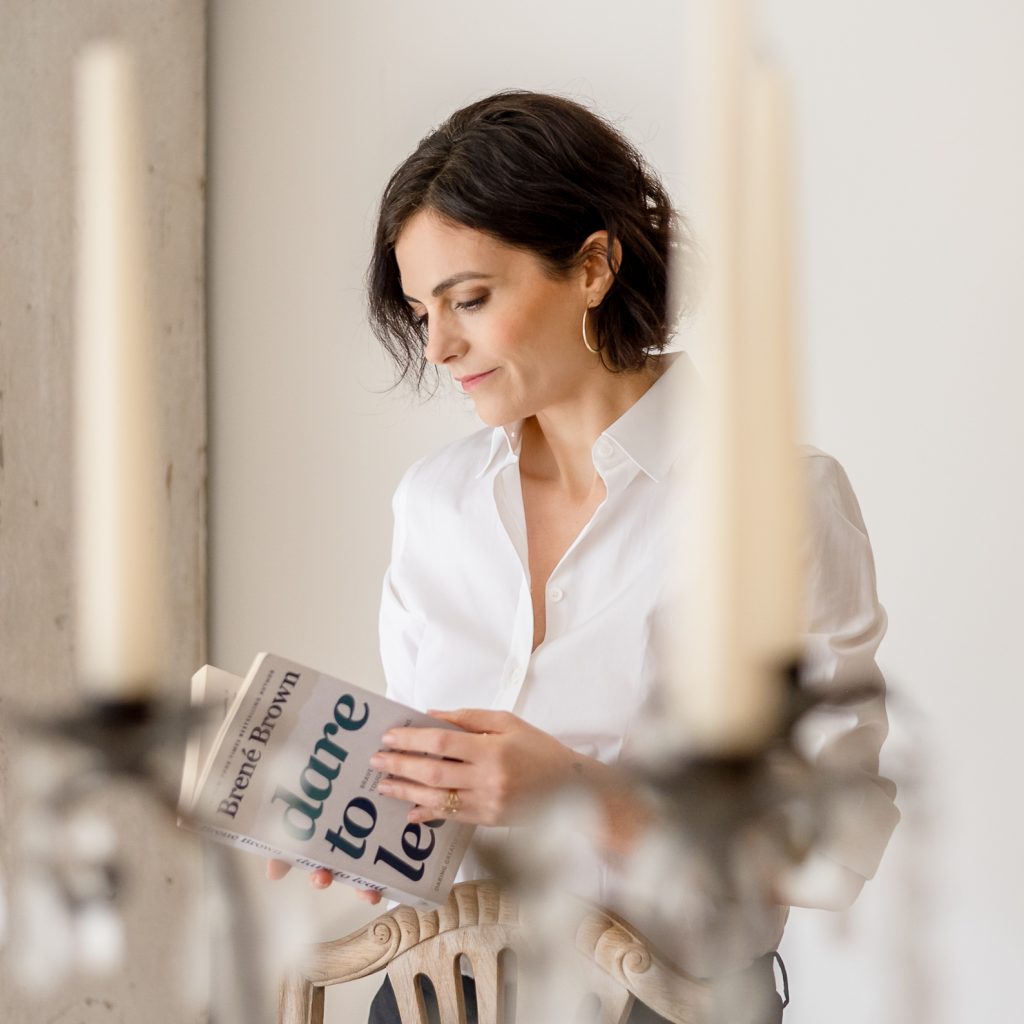 Personal Branding Woman browsing through book 'Dare to Lead' by Brene Brown for a Personal Branding photoshoot in Richmond Upon Thames